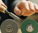 Which type of grinding wheel is more economical for hand tool sharpening?